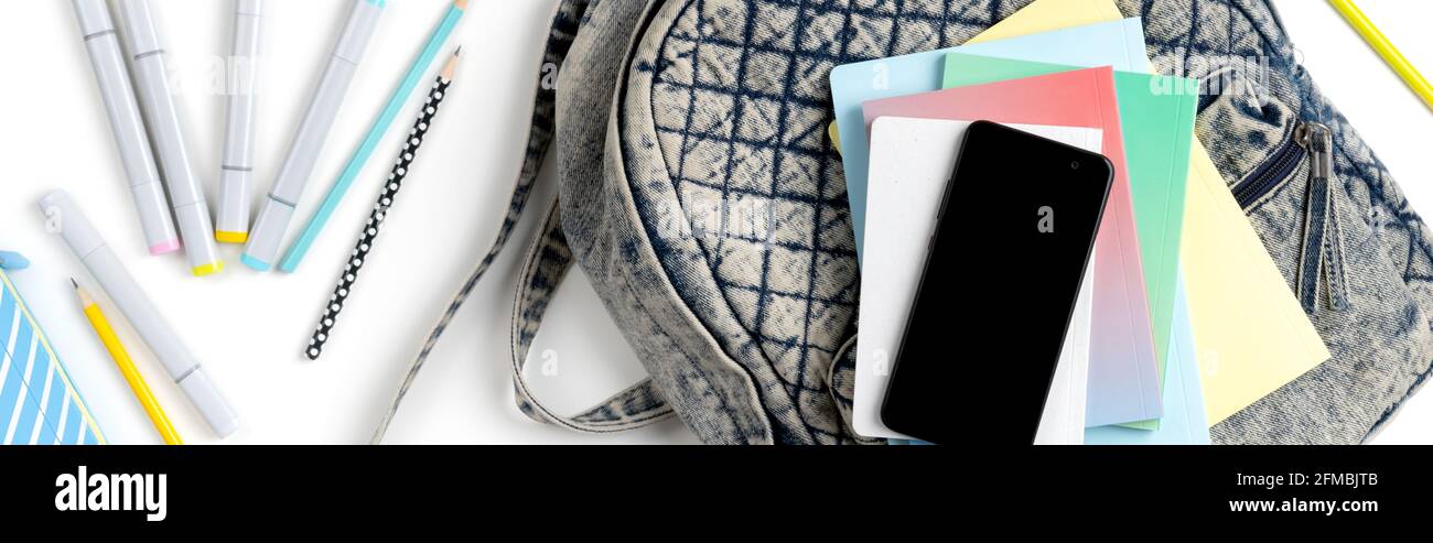 Flat lay top view backpack with different colorful stationery Stock Photo