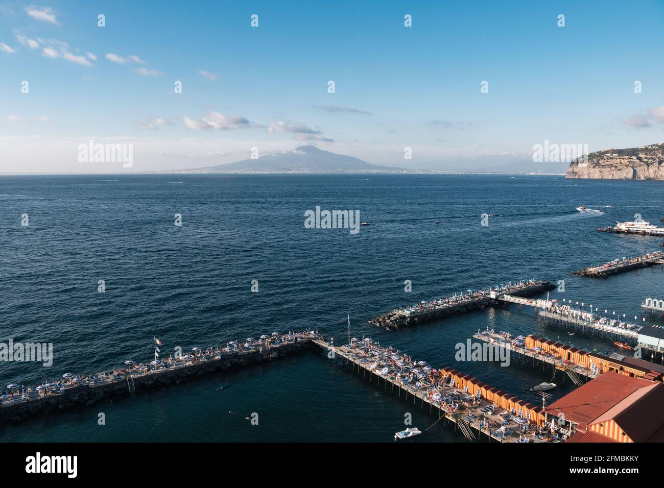 Sorrento, Campania, Italy - August 26 2020: Leonelli's Beach Solarium and the Bay of Naples with Mount Vesuvius and the Tyrrhenian Sea Stock Photo