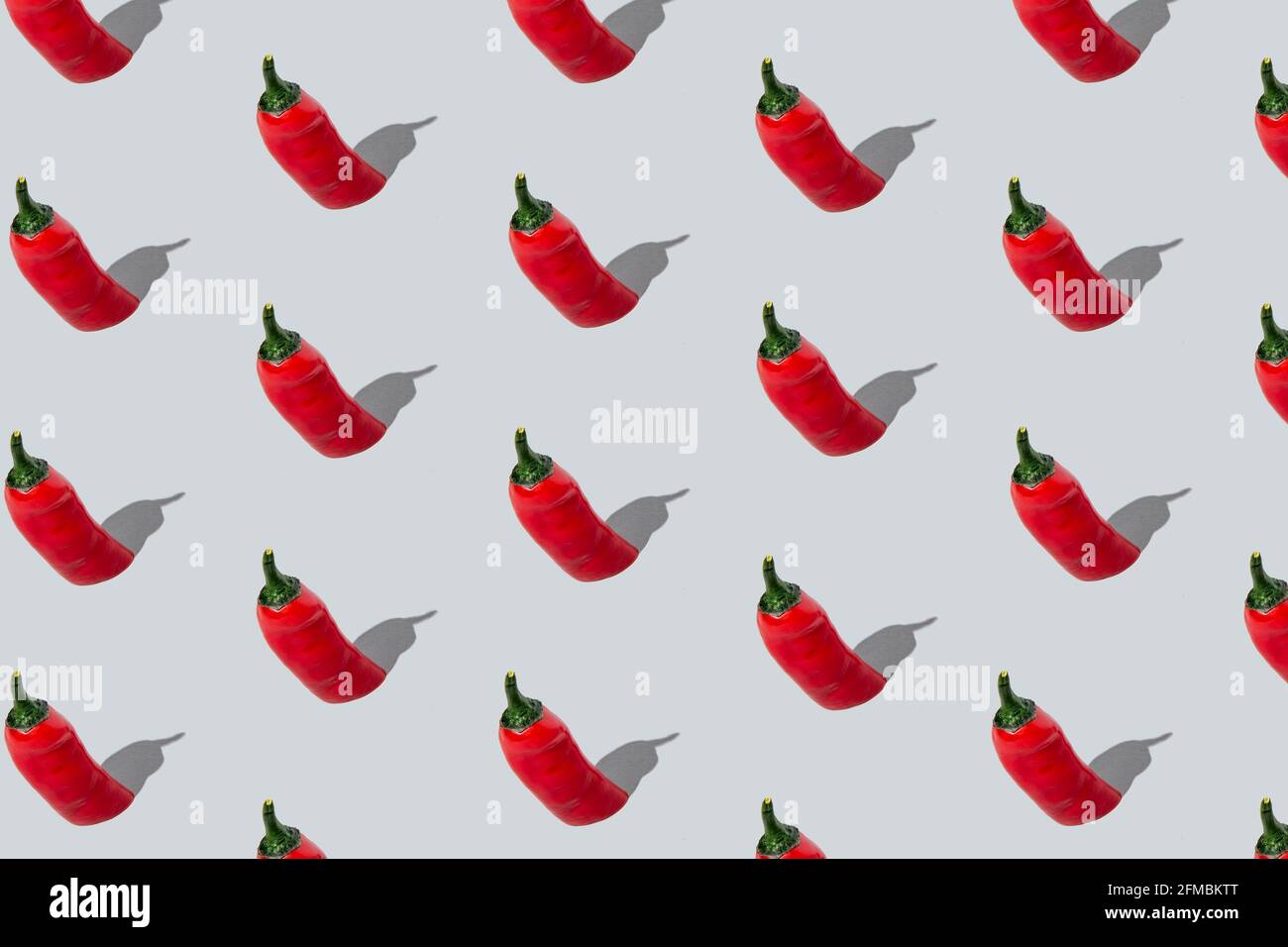 Seamless red chili peppers pattern on light grey background. Isometric layout. Stock Photo