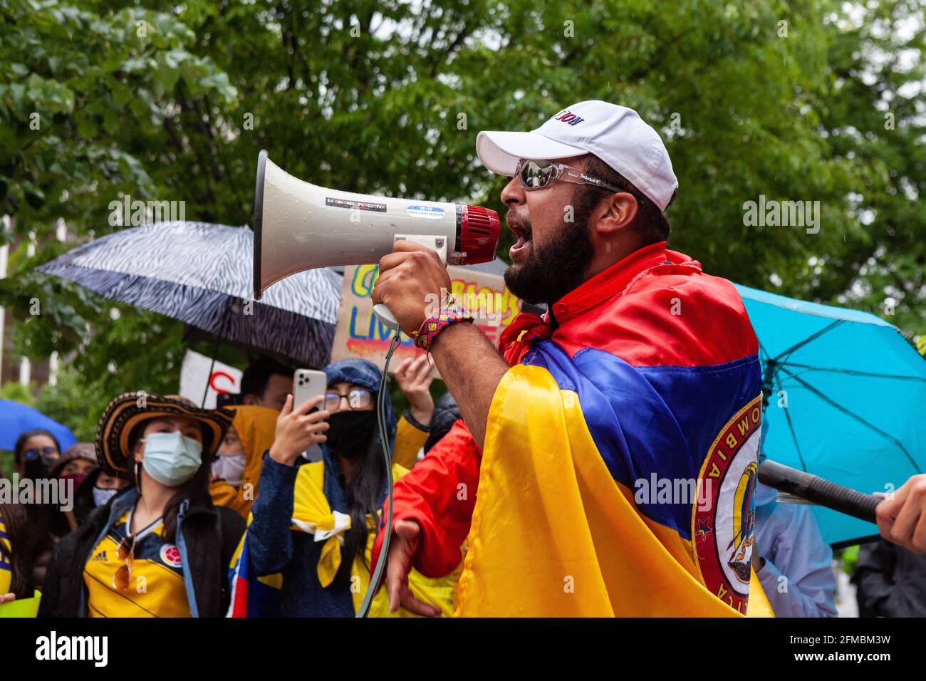 Washington DC, USA. 07th May, 2021. A man fires up the crowd during a protest against the Colombian government's violent, disproportionate response to peaceful protests by unarmed citizens over taxes, equality, and response to the coronavirus pandemic. Credit: Allison Bailey/Alamy Live News Stock Photo