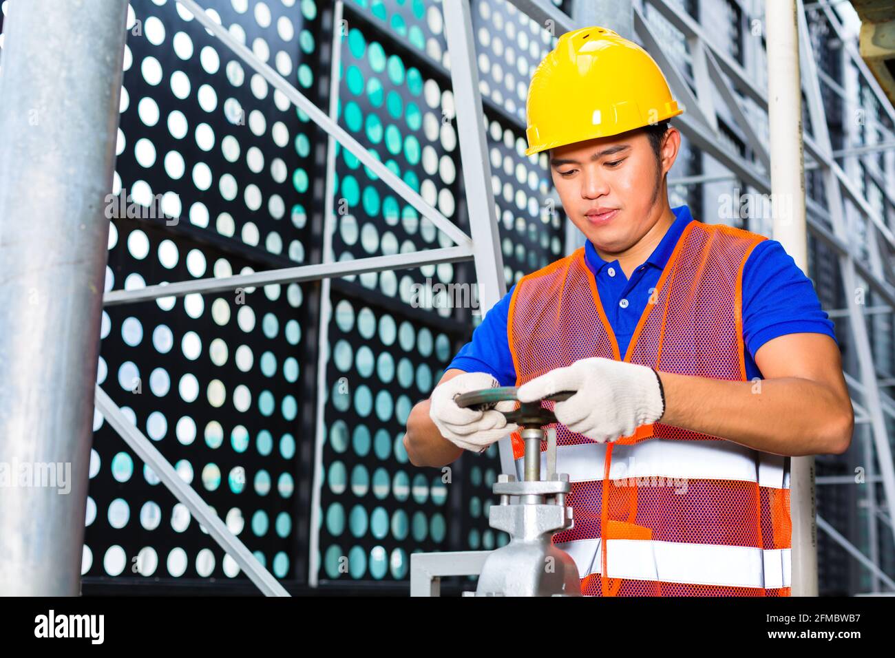 technician or engineer working on a valve on building technical ...