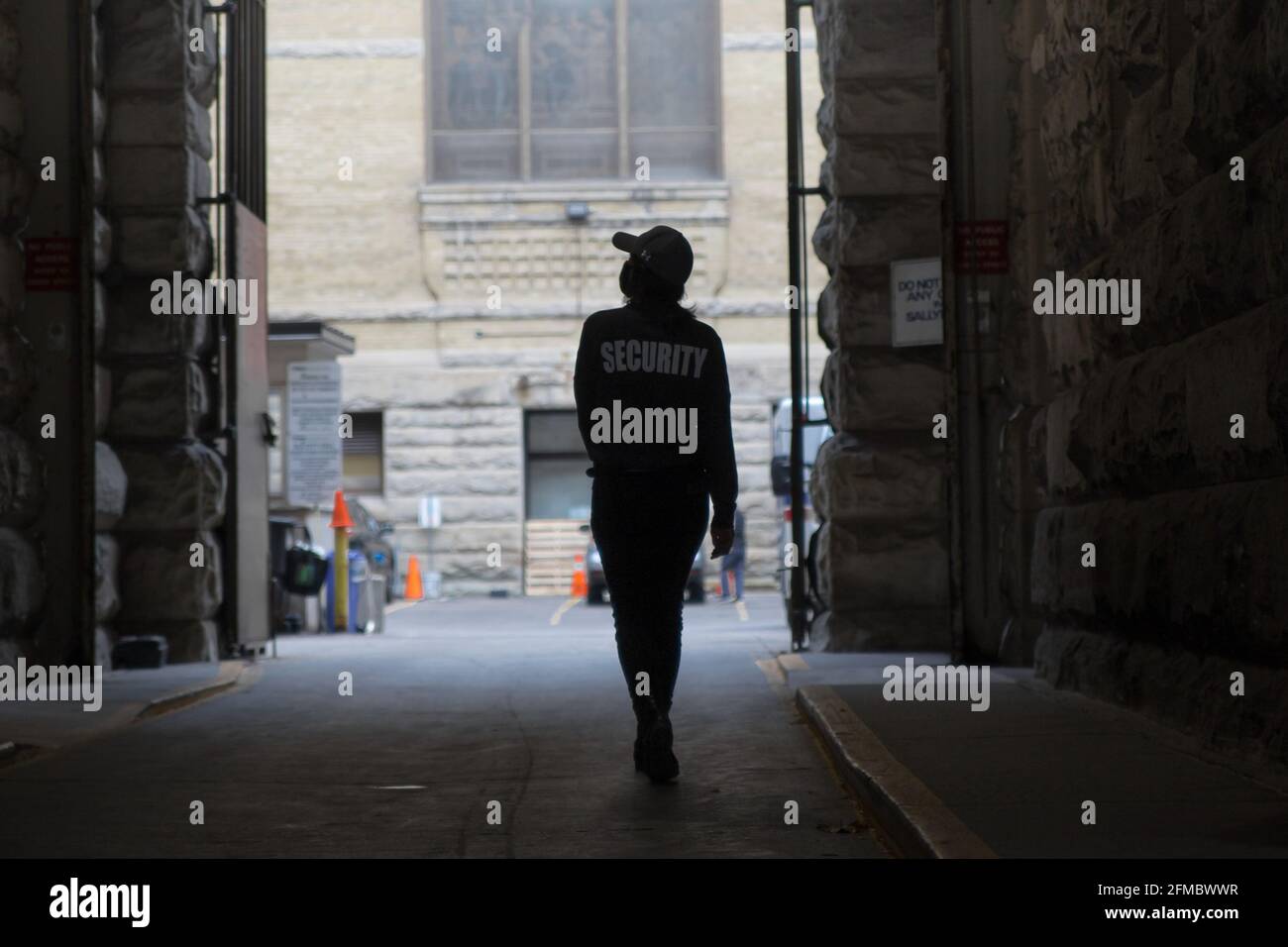 A view of a security guard in uniform patrolling a residential area ...