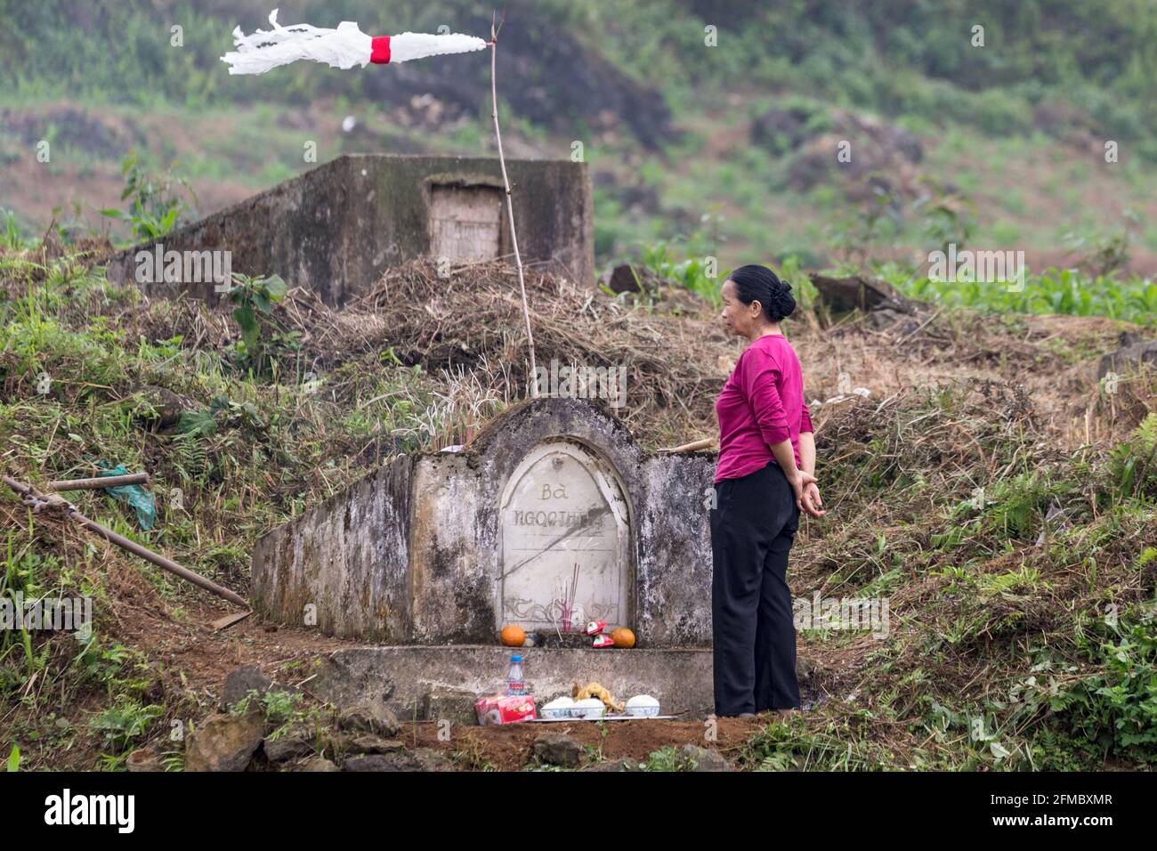 Annual visiting ancestors graves bearing gifts and lighting fires in