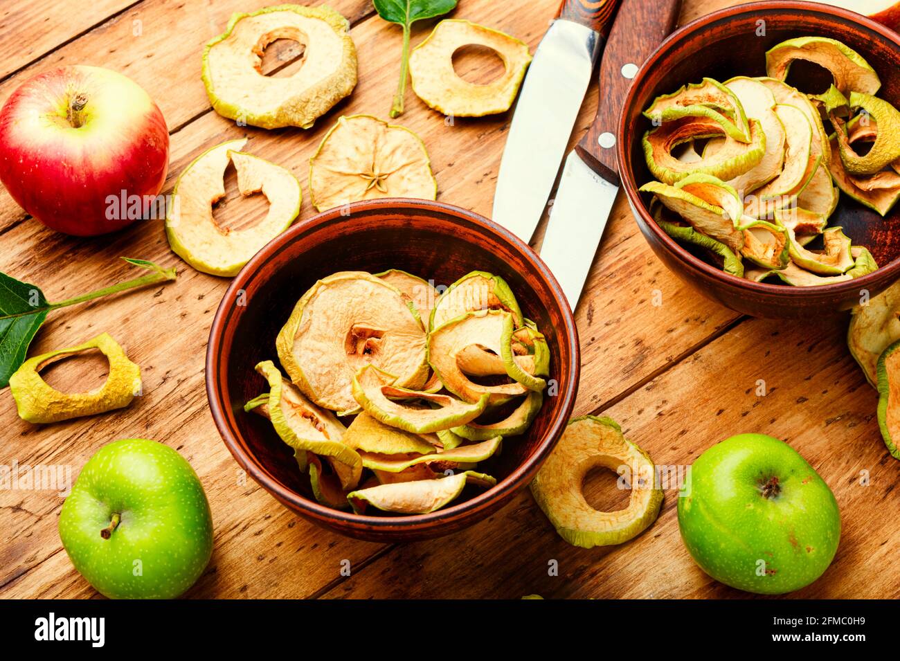 Apple chips on rustic wooden background.Dried apples Stock Photo
