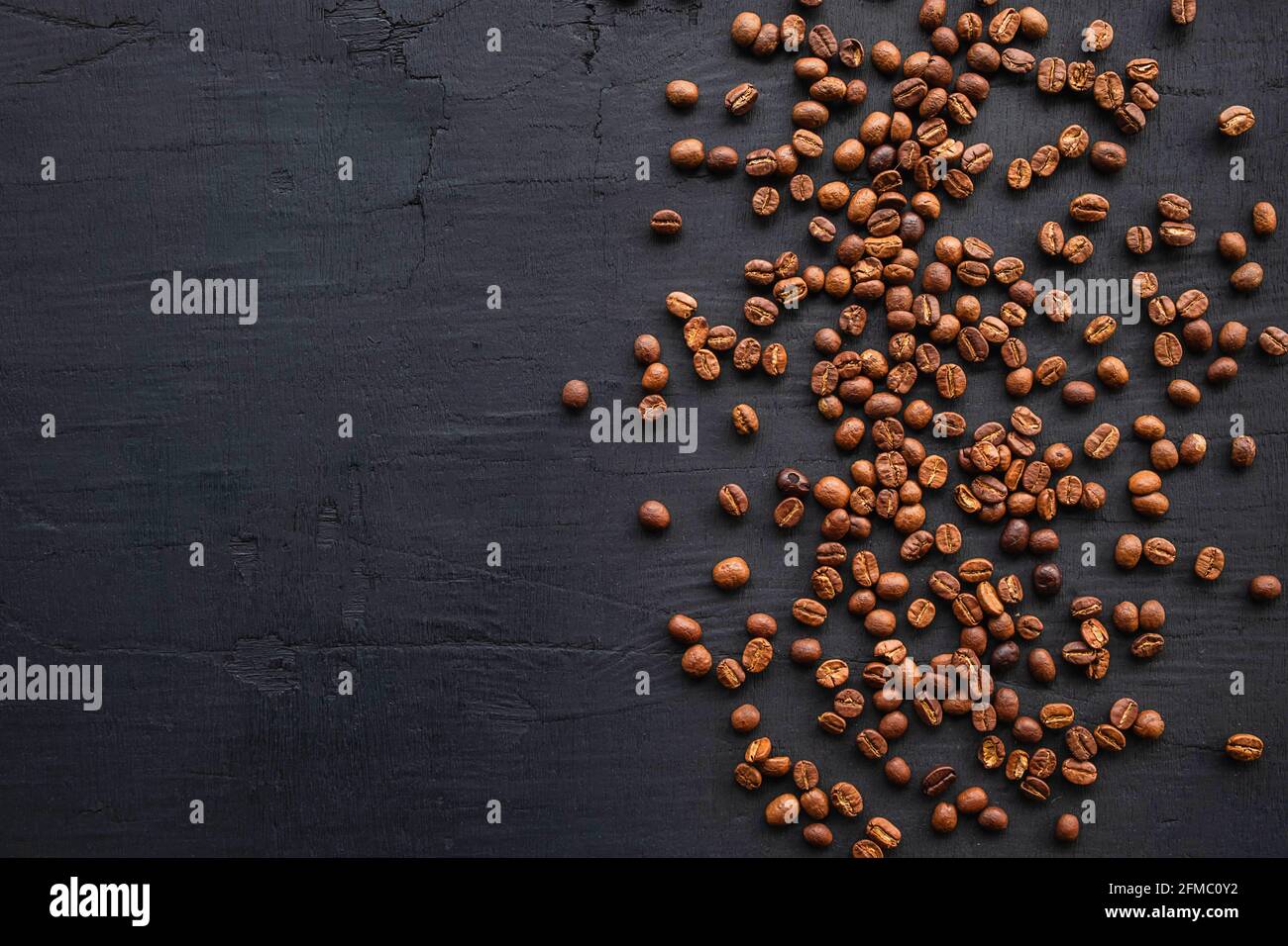 Coffee beans roasted on a black background Stock Photo - Alamy