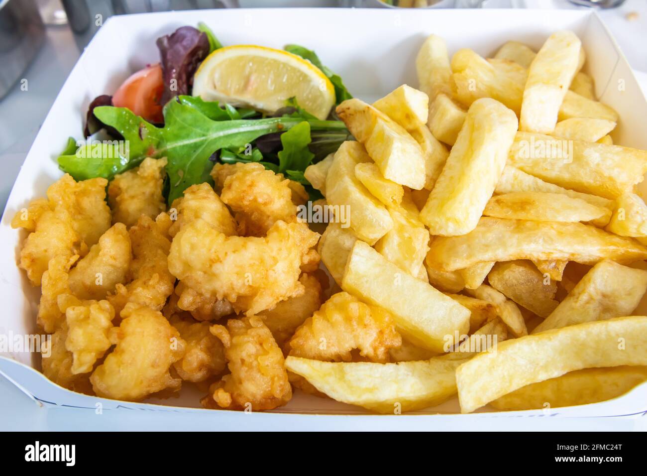 Scottish Pittenweem prawns deep fried in batter with French fries. Stock Photo