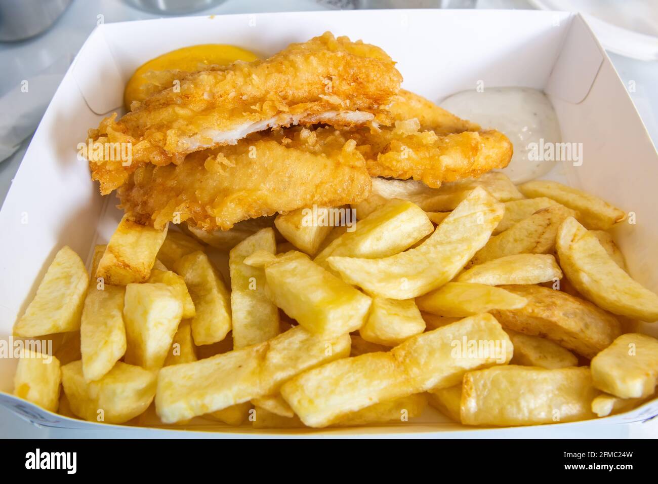 Fresh Scottish haddock deep fried in light, crispy batter. Stock Photo
