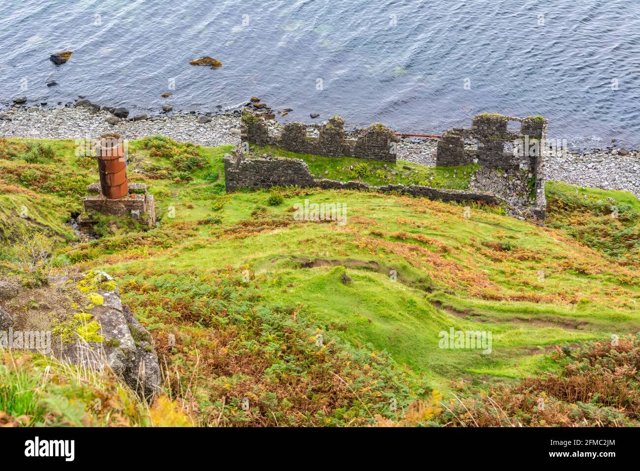 Remains of the drying shed and chimney of diatomite works on the Lealt coast in the Isle of Skye, Scotland. The drying shed was where the diatomite wa Stock Photo