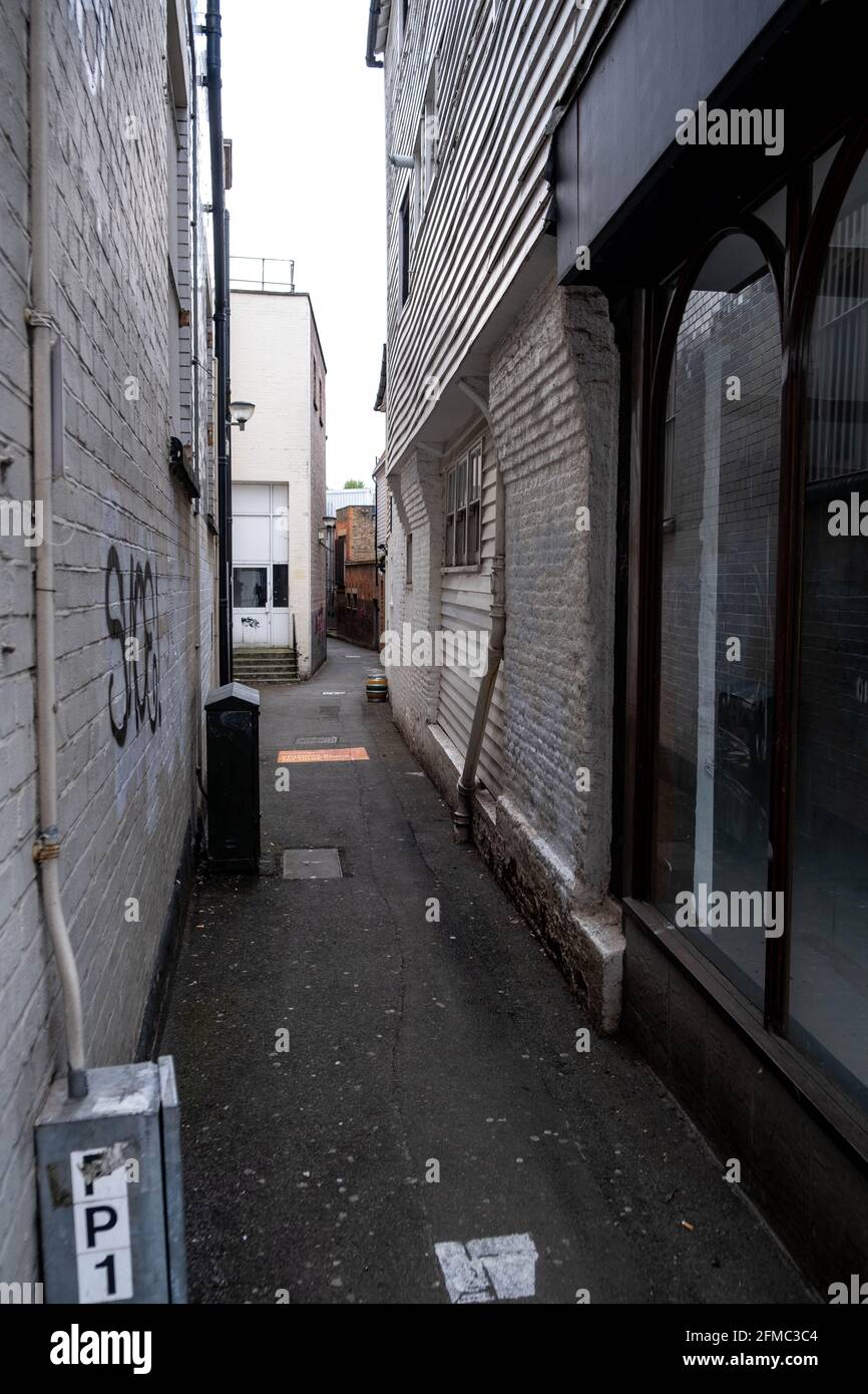 Kingston Upon Thames London UK, May 07 2021, Dark Narrow Inner City Alley Pathway With No People Stock Photo