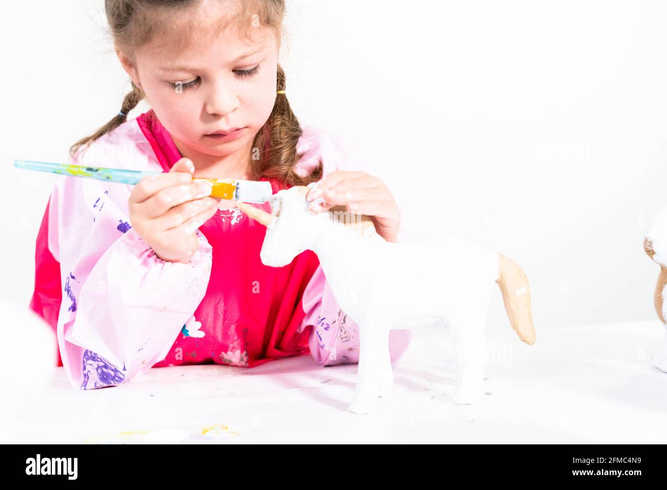 Little girl working on her art project for distance learning at home during COVID-19 pendemic. Stock Photo