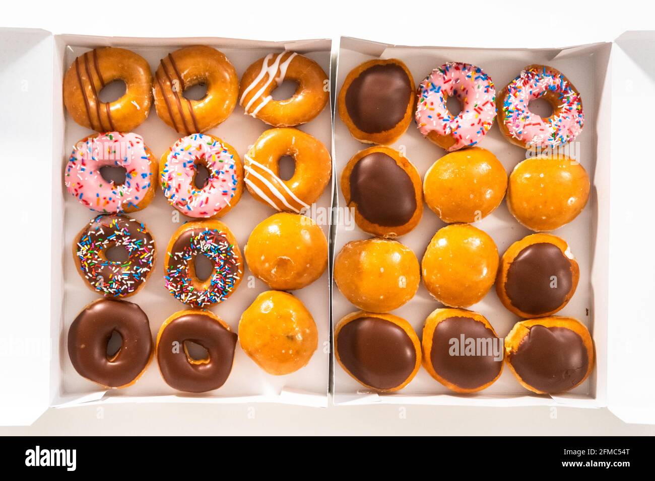 Flat lay. Variety of storebought doughnuts in a white paper box Stock