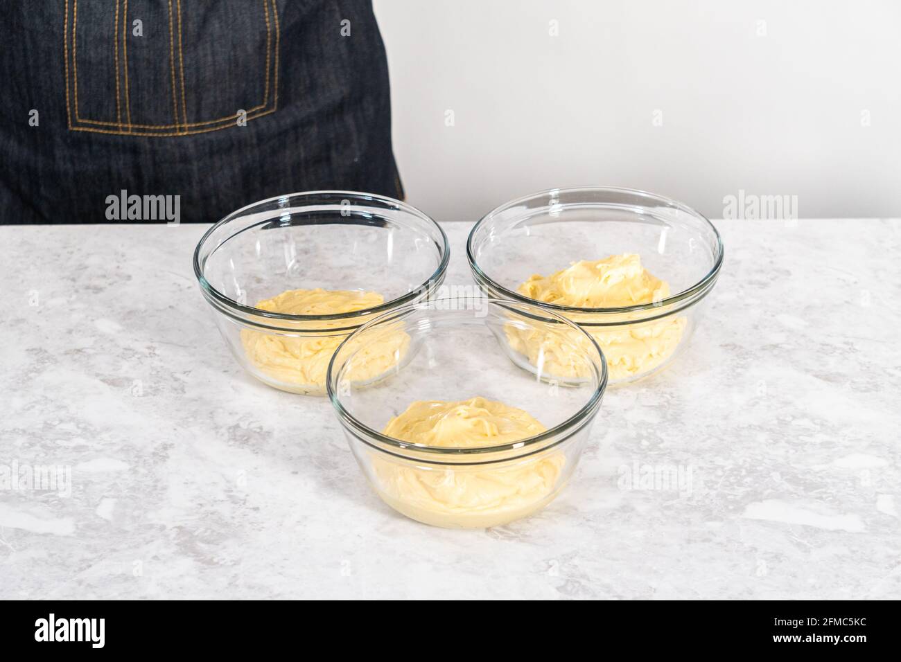Mixing red and blue food coloring into the cake dough Stock Photo Alamy