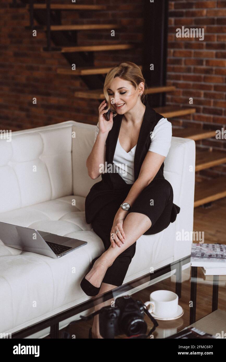 Beautiful business woman decides issues by talking on the phone. Soft selective focus, defocus. Stock Photo