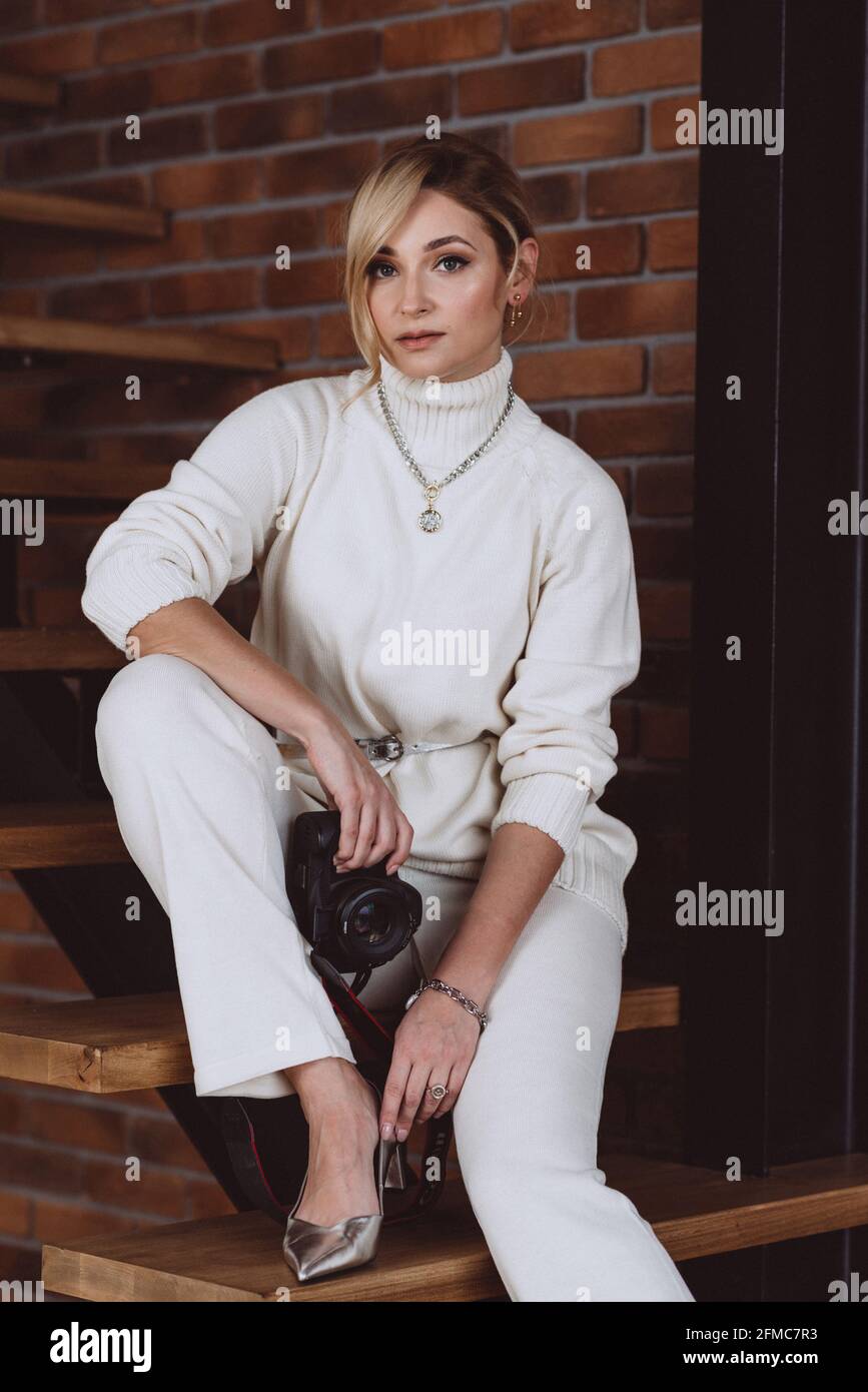 Beautiful woman photographer, fashion blogger, vlogger, with a camera in  her hands. Soft selective focus, defocus, art noise Stock Photo - Alamy