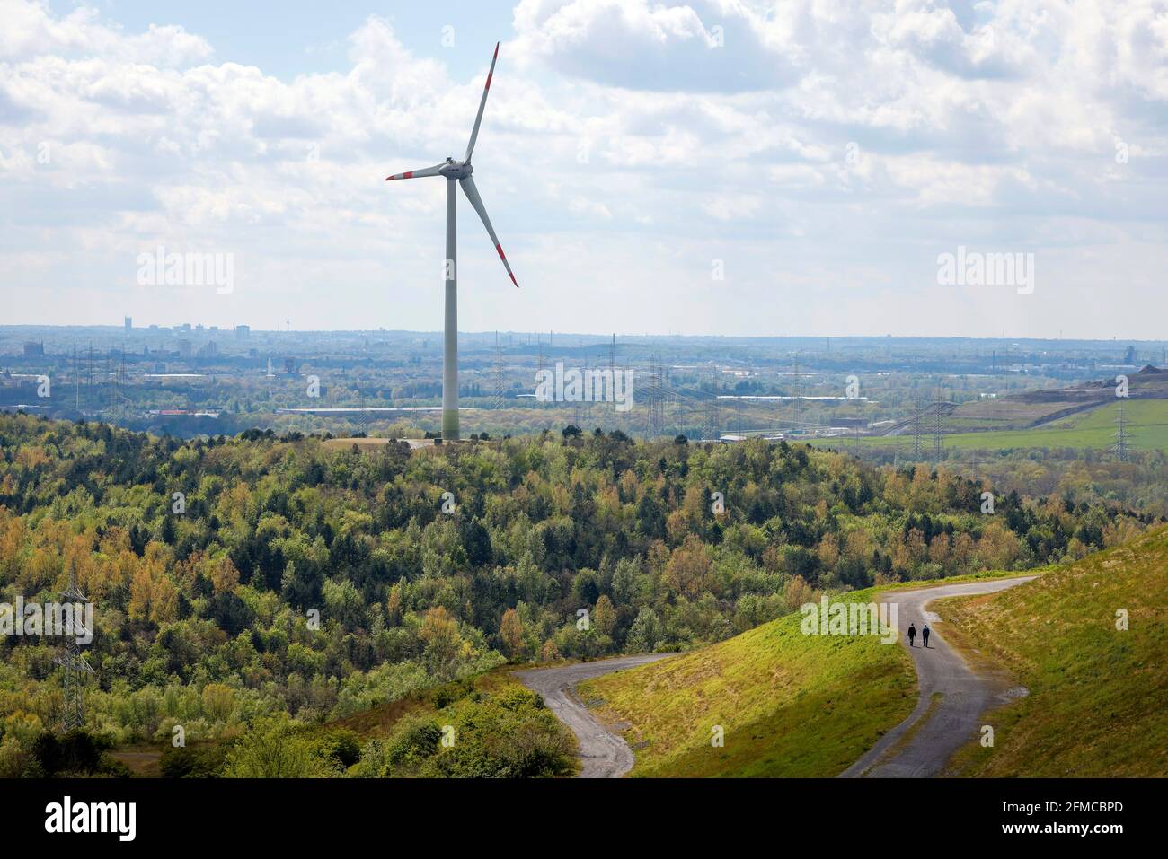 Herten, Ruhr area, North Rhine-Westphalia, Germany - Windmill and walker at the Hoheward slagheap in Herten. Stock Photo