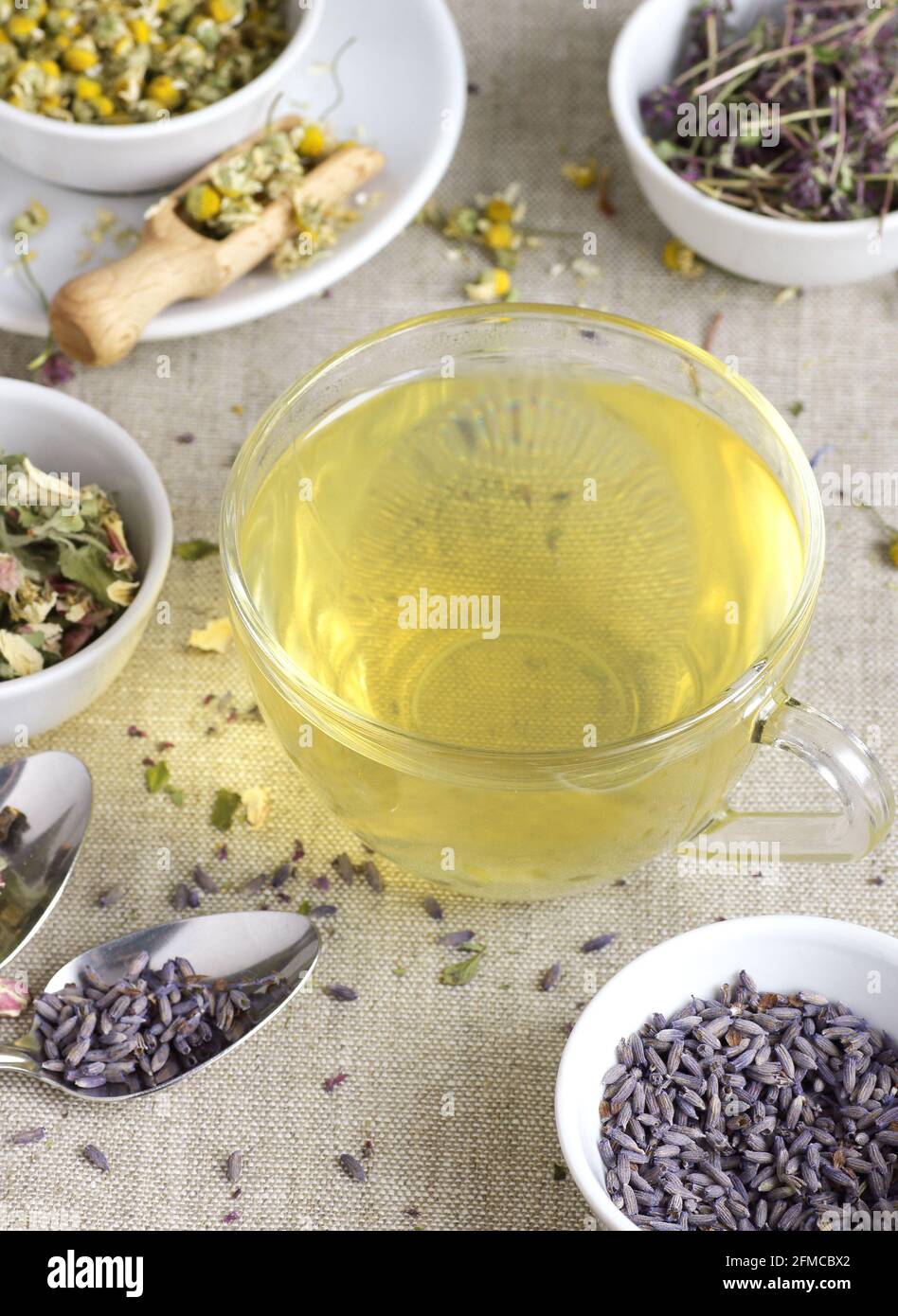 Chamomile herbal tea in glass cup and jar with dry herb flowers, above overhead view, naturopathy, natural medicine, healing drinks for sleep, skin an Stock Photo