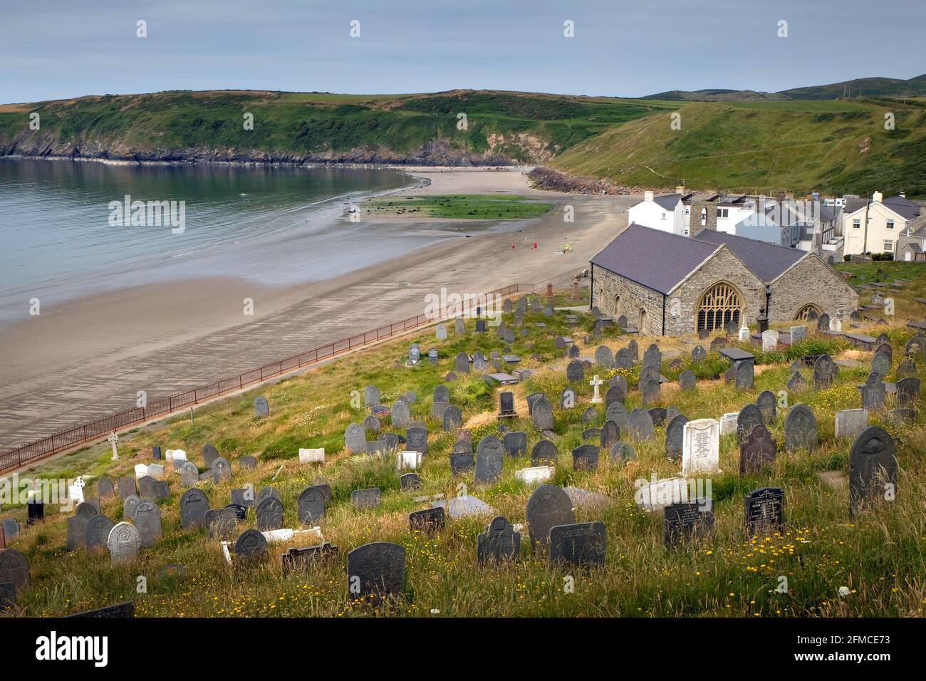 Church and graveyard of St Hywyn, Aberdaron, Gwynedd, on the Lyn Peninsula, Wales. Church and graveyard overlook the beach and date from 12th Century Stock Photo
