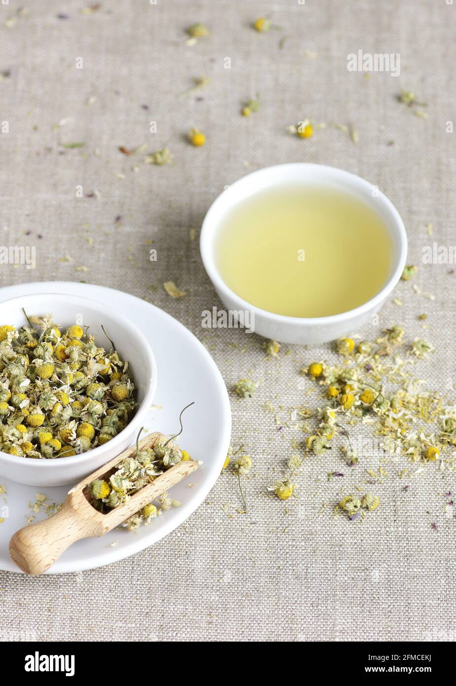 Chamomile herbal tea in chinese cup and glass jar with dry herb flowers, above overhead view, naturopathy, natural medicine, healing drinks for sleep, Stock Photo