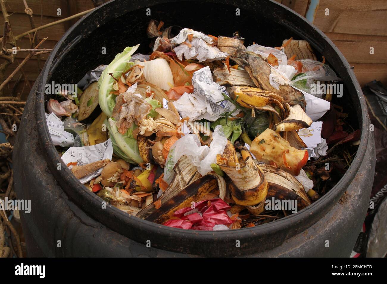 Contents of an outdoor compost bin including vegetable waste to produce environmentally friendly garden compost and reduce waste. Stock Photo