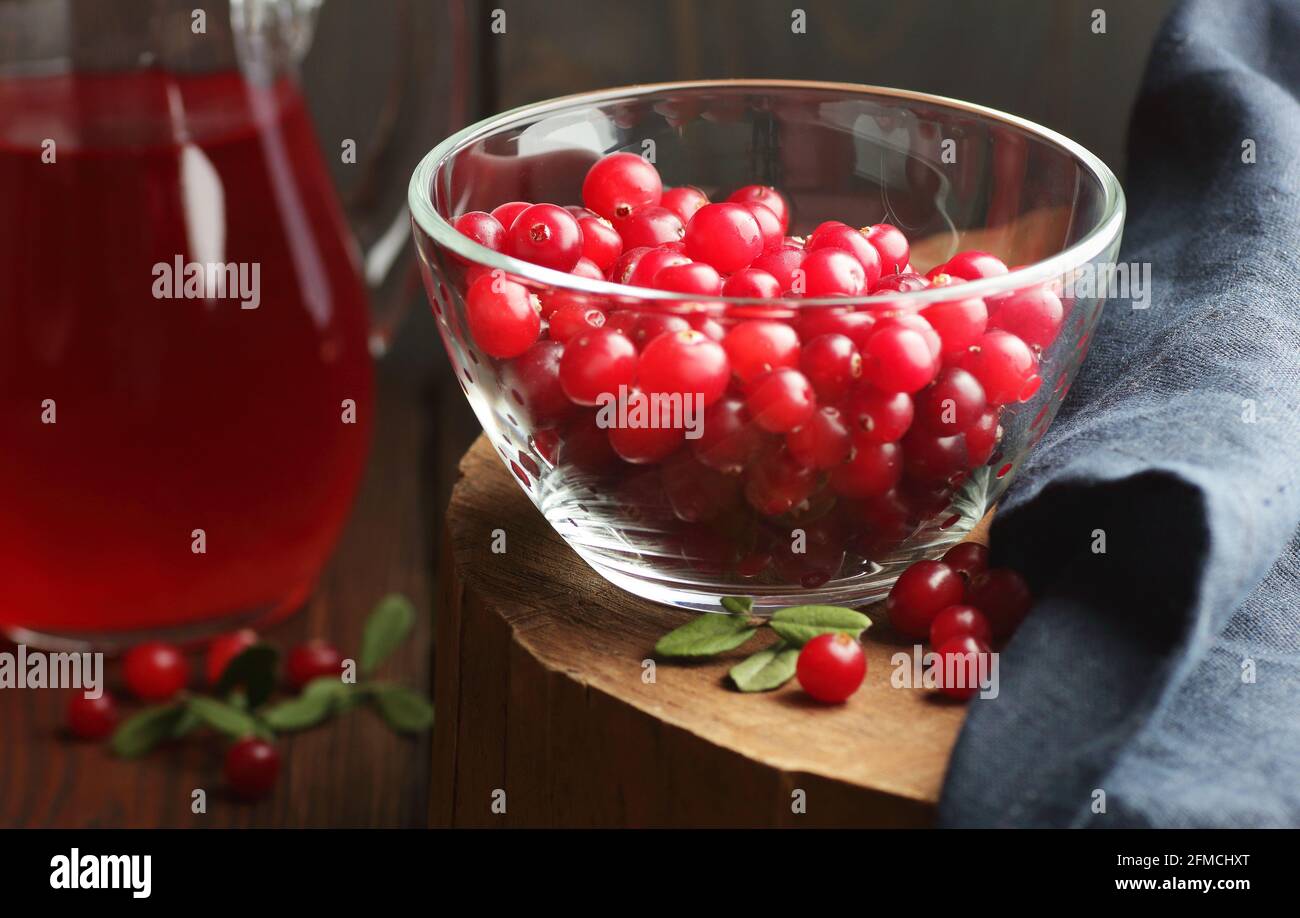 Cranberry berries in a glass bowl on wooden rustic background, closeup, winter christmas holiday vitamins, healthy healing food, natural medicine and Stock Photo