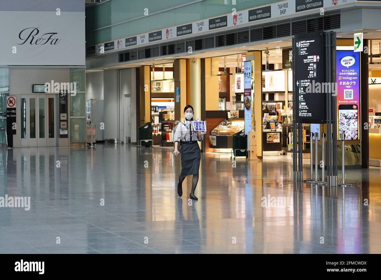 An airline staff wearing a face mask walks at an empty Chubu Centrair International Airport terminal. Japan extends the state of emergency until the end of May and strengthens the lockdown measures as the number of infection cases stays high amid coronavirus pandemic. (Photo by Jinhee Lee / SOPA Images/Sipa USA) Stock Photo