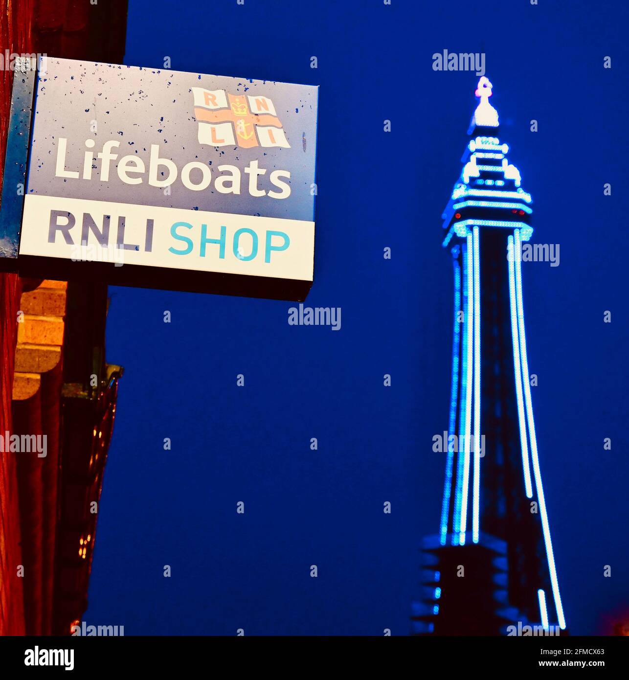 Illuminated Blackpool Tower and RNLI shop sign at night Stock Photo Alamy