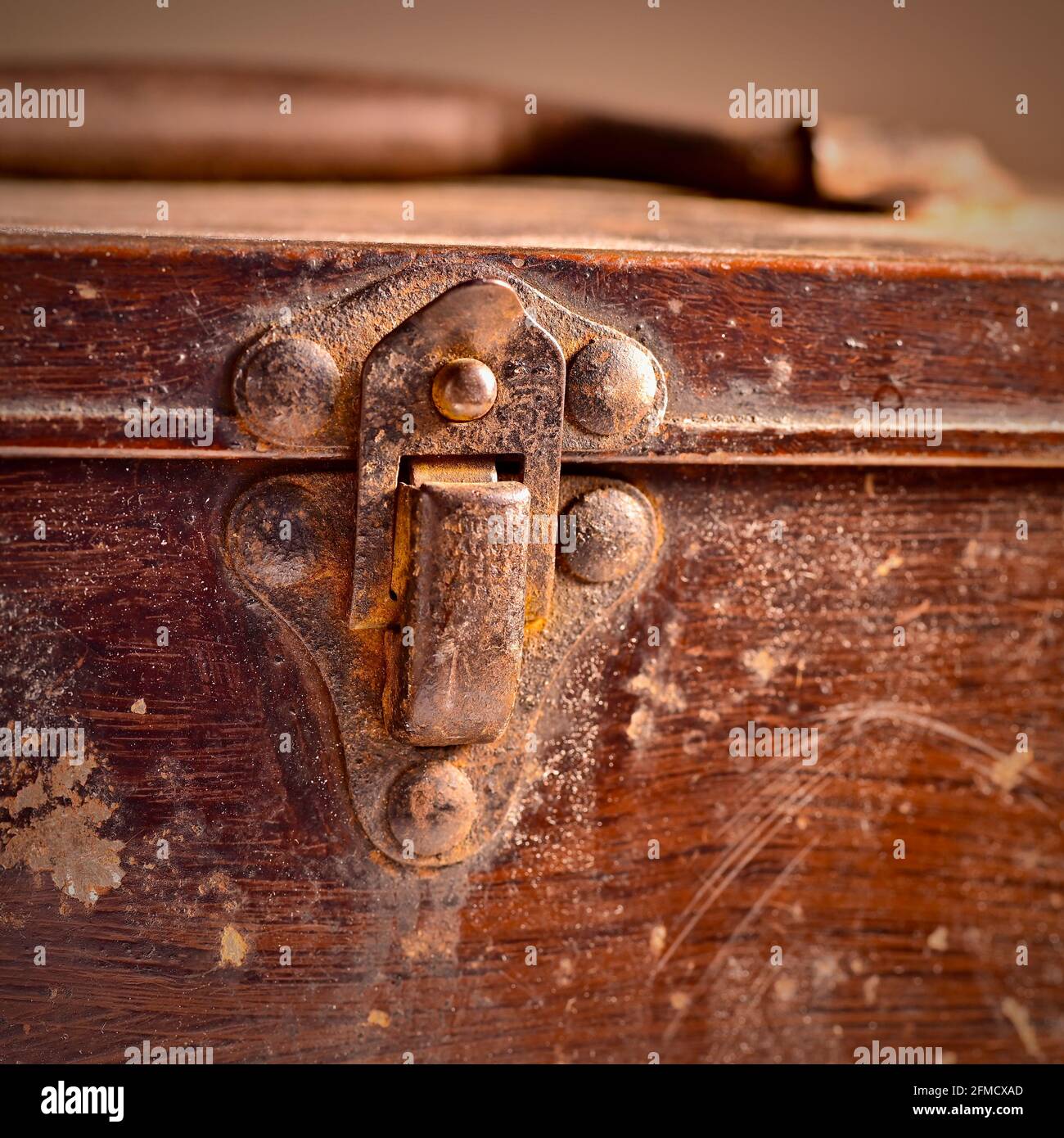 Rusting metal clasp and handle on old tin box Stock Photo