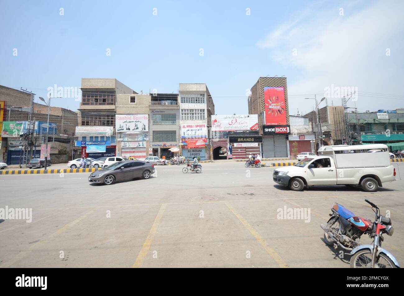 Motorcyclists navigating a market with traffic restrictions