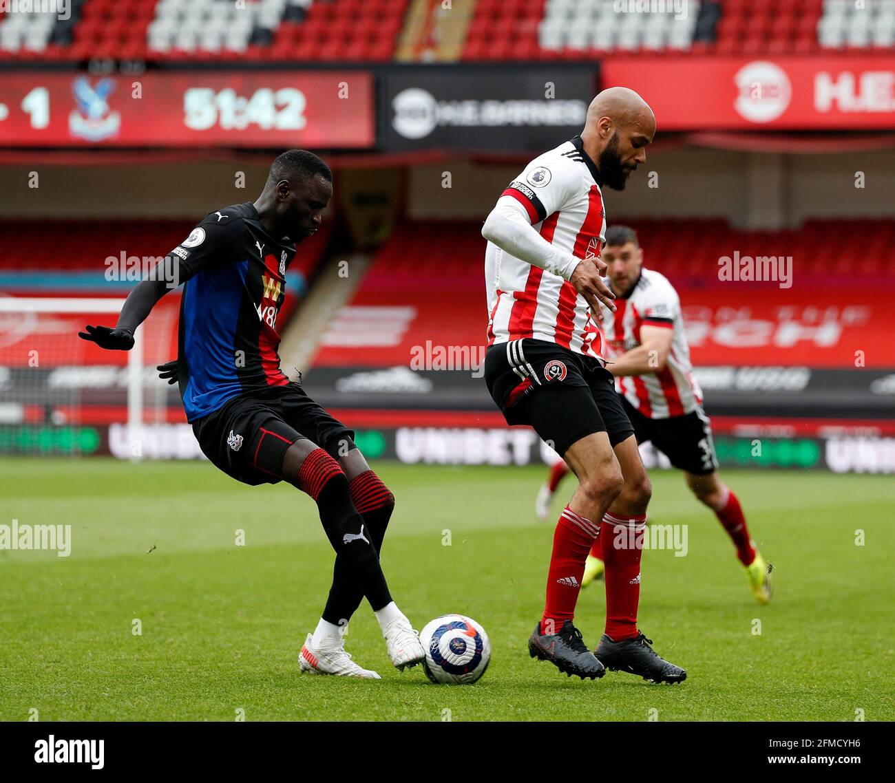 Sheffield, England, 8th May 2021. David McGoldrick of Sheffield Utd tussles with Chikhou Kouyate of Crystal Palace during the Premier League match at Bramall Lane, Sheffield. Picture credit should read: Darren Staples / Sportimage Stock Photo