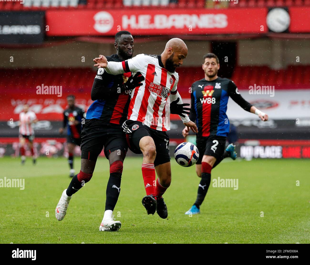 Sheffield, England, 8th May 2021. David McGoldrick of Sheffield Utd tussles with Chikhou Kouyate of Crystal Palace during the Premier League match at Bramall Lane, Sheffield. Picture credit should read: Darren Staples / Sportimage Stock Photo