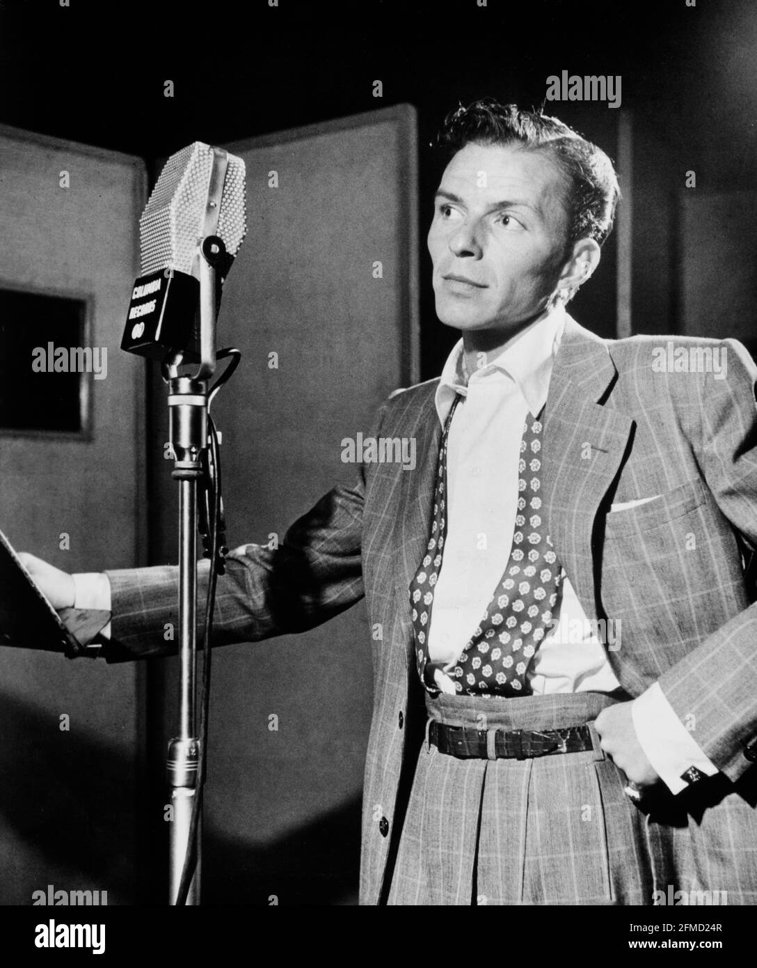 Frank Sinatra with microphone, in the studio, black and white photo by William Gottlieb. Stock Photo