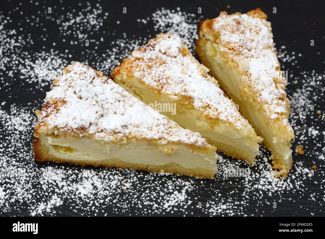 pieces cheesecake with crumble on black plate Stock Photo