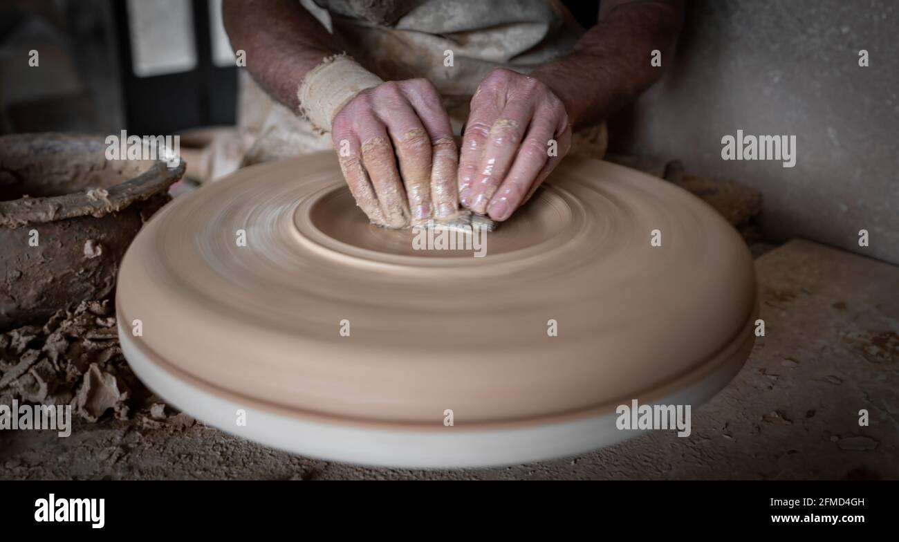 Potter hands working carefully on pottery, closeup view Stock Photo