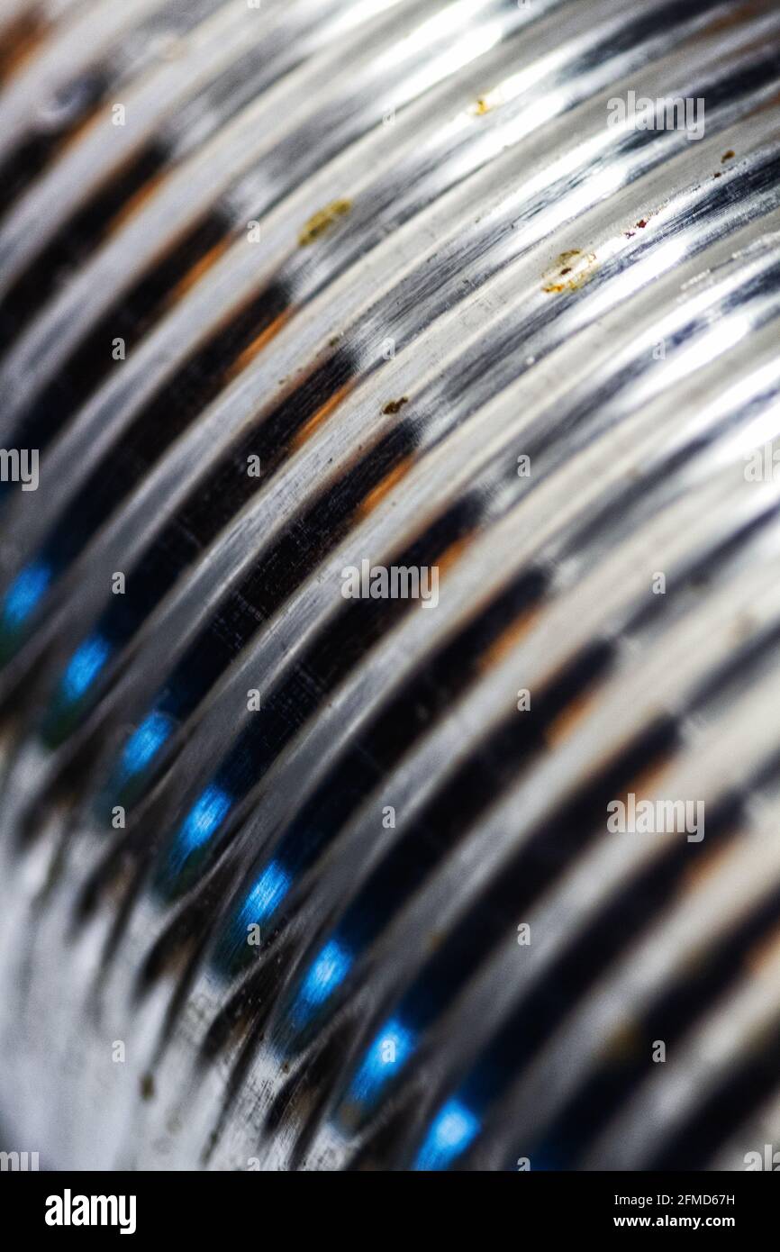 A macro shot of a tin can creates a geometric design of parallel lines of light and shadows. Stock Photo