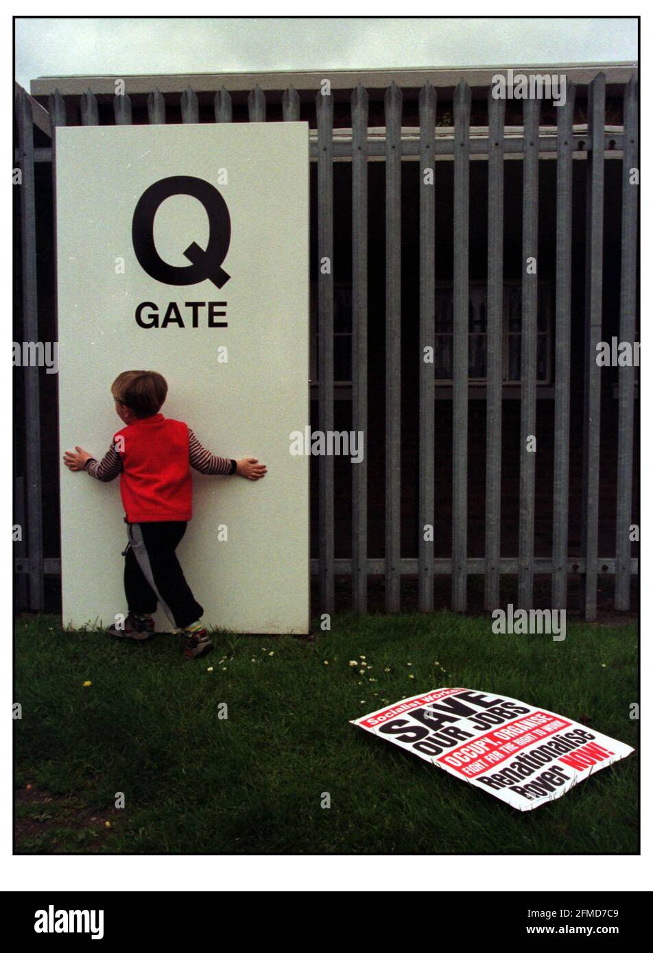 Young Cameron Robinson (3.5 yrs)plays outside the main gate of Longbridge Rover, Birmingham while waiting for his father Shop Steward Ian Robinson one of the delegation who have been to Germany to meet with BMW management.pic David Sandison 28/4/00 Stock Photo