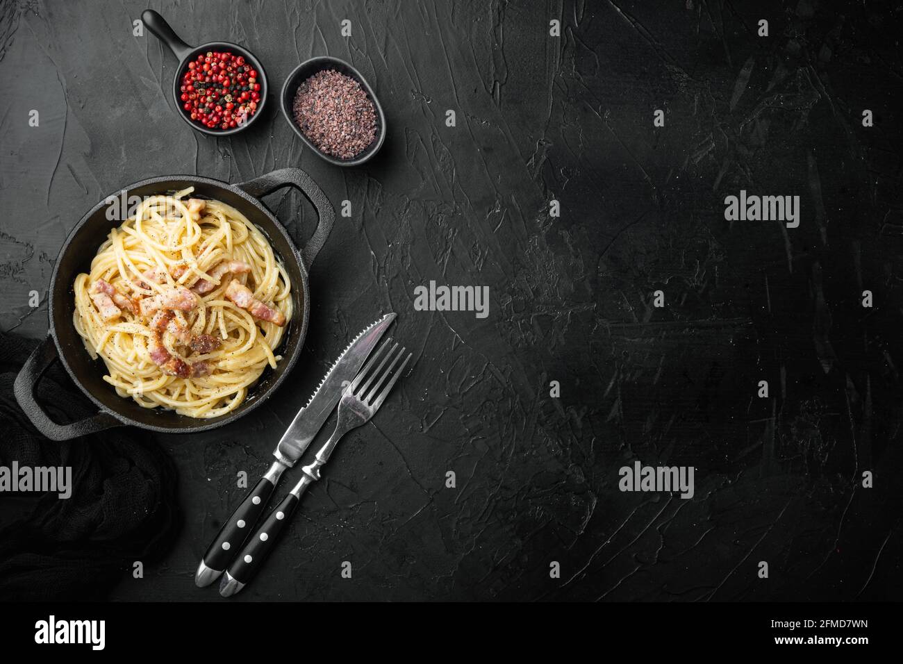 Dish Of Spaghetti Carbonara Modern Italian Recipe Of Pasta With Guanciale Egg Ad Pecorino Romano Cheese Set In Cast Iron Frying Pan On Black Stone Stock Photo Alamy