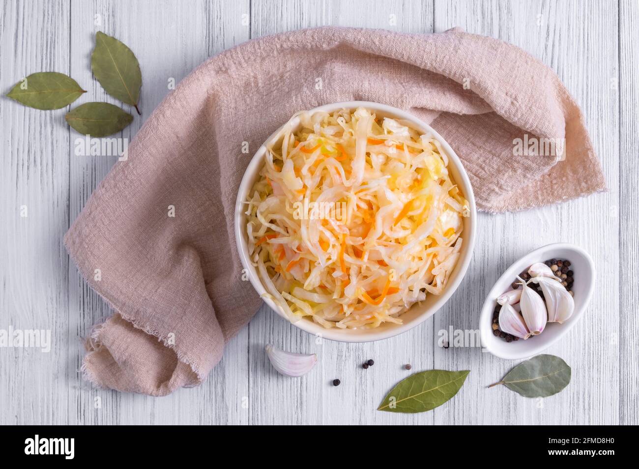 Ceramic bowl with fermented sauerkraut and spices Stock Photo