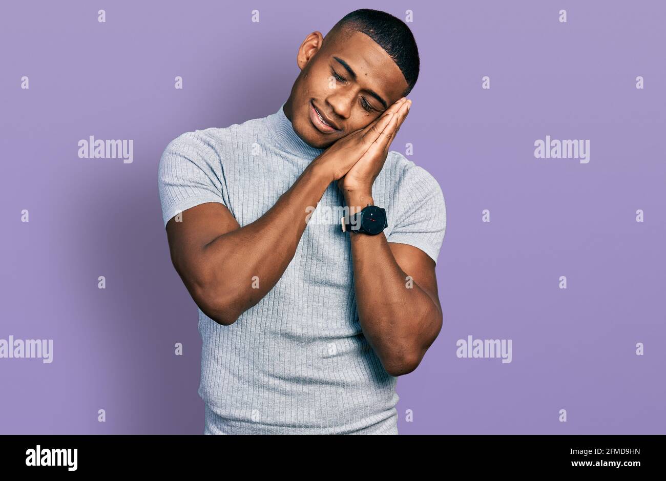Young black man wearing casual t shirt sleeping tired dreaming and ...