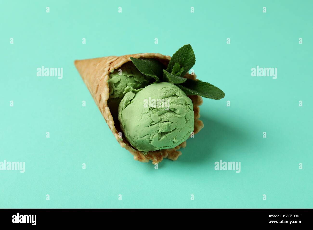 Cone of mint ice cream on mint background Stock Photo Alamy