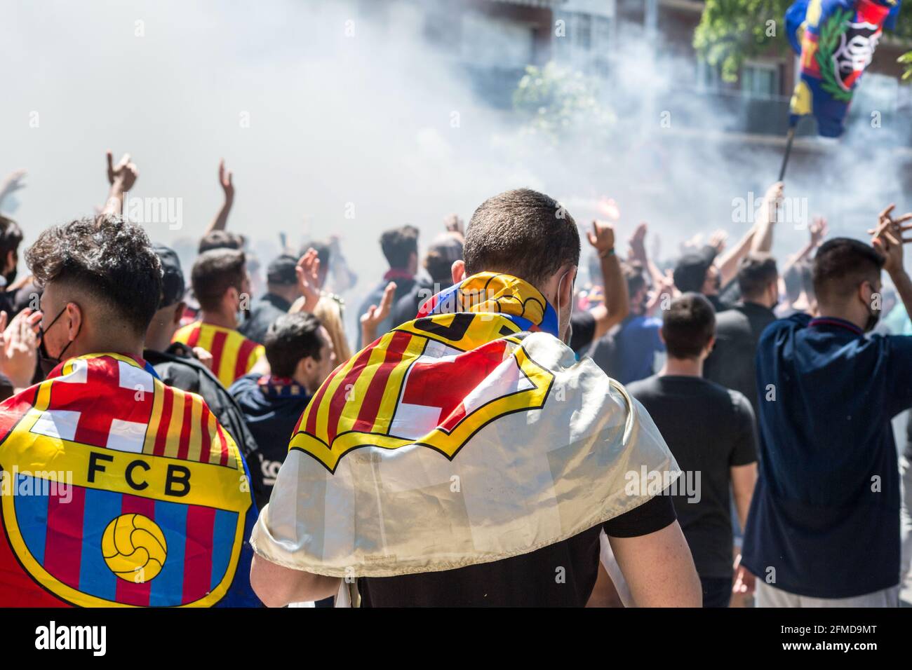 Barcelona, Spain. 08th May, 2021. Fans are seen wrapped with Football Club Barcelona flags. The ultras supporter group of Football Club Barcelona, Boixos Nois (Crazy Boys) have gathered outside the Camp Nou stadium to motivate the team before the match against Club Atletico de Madrid for the 35th round of La Liga, the Spanish football league. Barça's victory will put the team, currently in third place, ahead of Atletico de Madrid, which occupies the first position. Credit: SOPA Images Limited/Alamy Live News Stock Photo