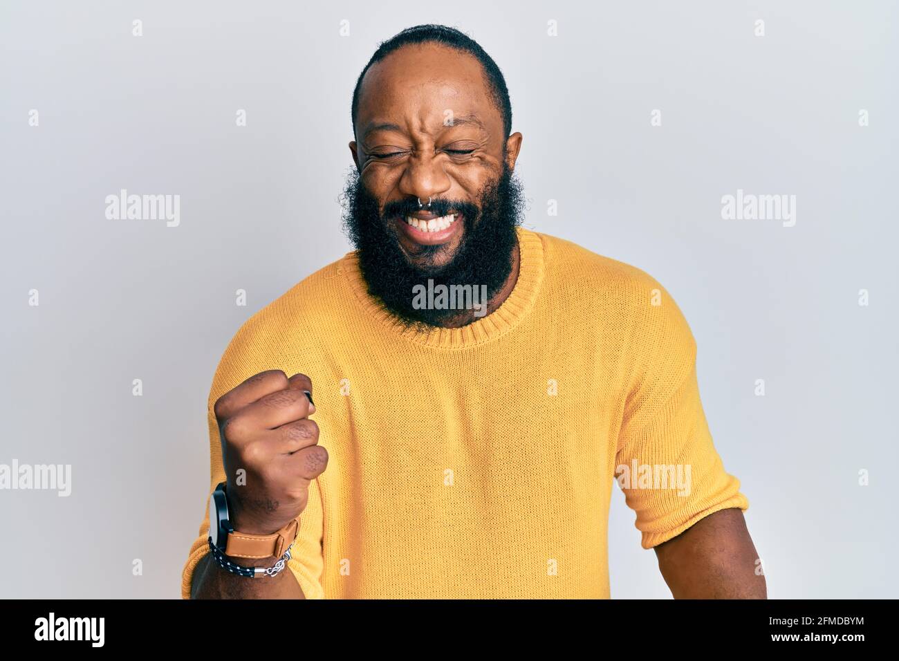 Young african american man wearing casual clothes celebrating surprised ...