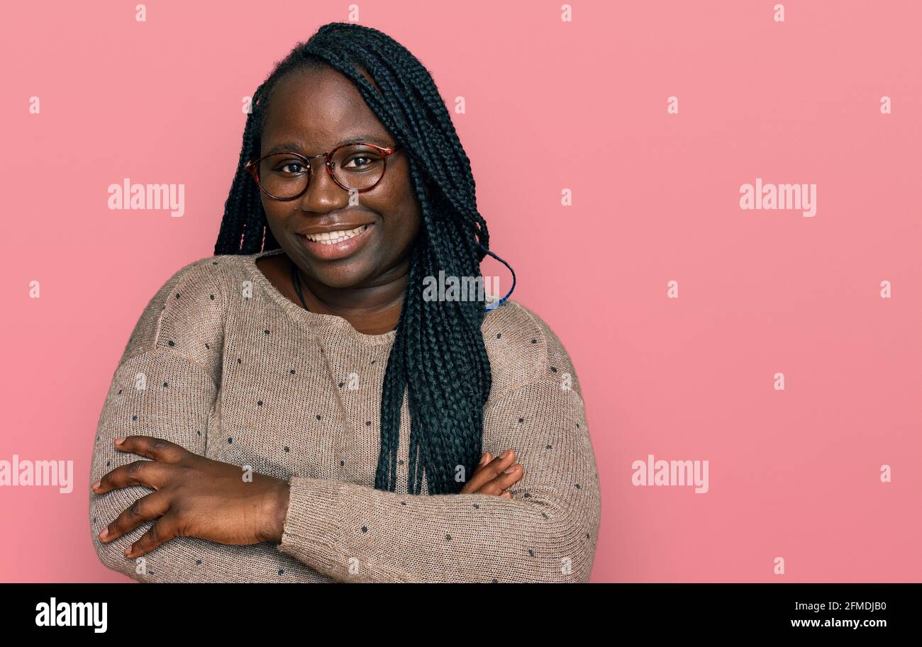 Young black woman with braids wearing casual clothes and glasses happy ...