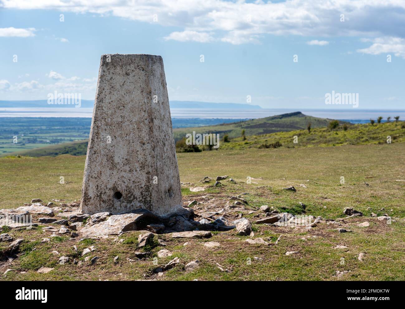 Trig point on Wavering Down in the Mendip HIlls of Somerset UK looking towards Crook peak and the Bristol Channel Stock Photo