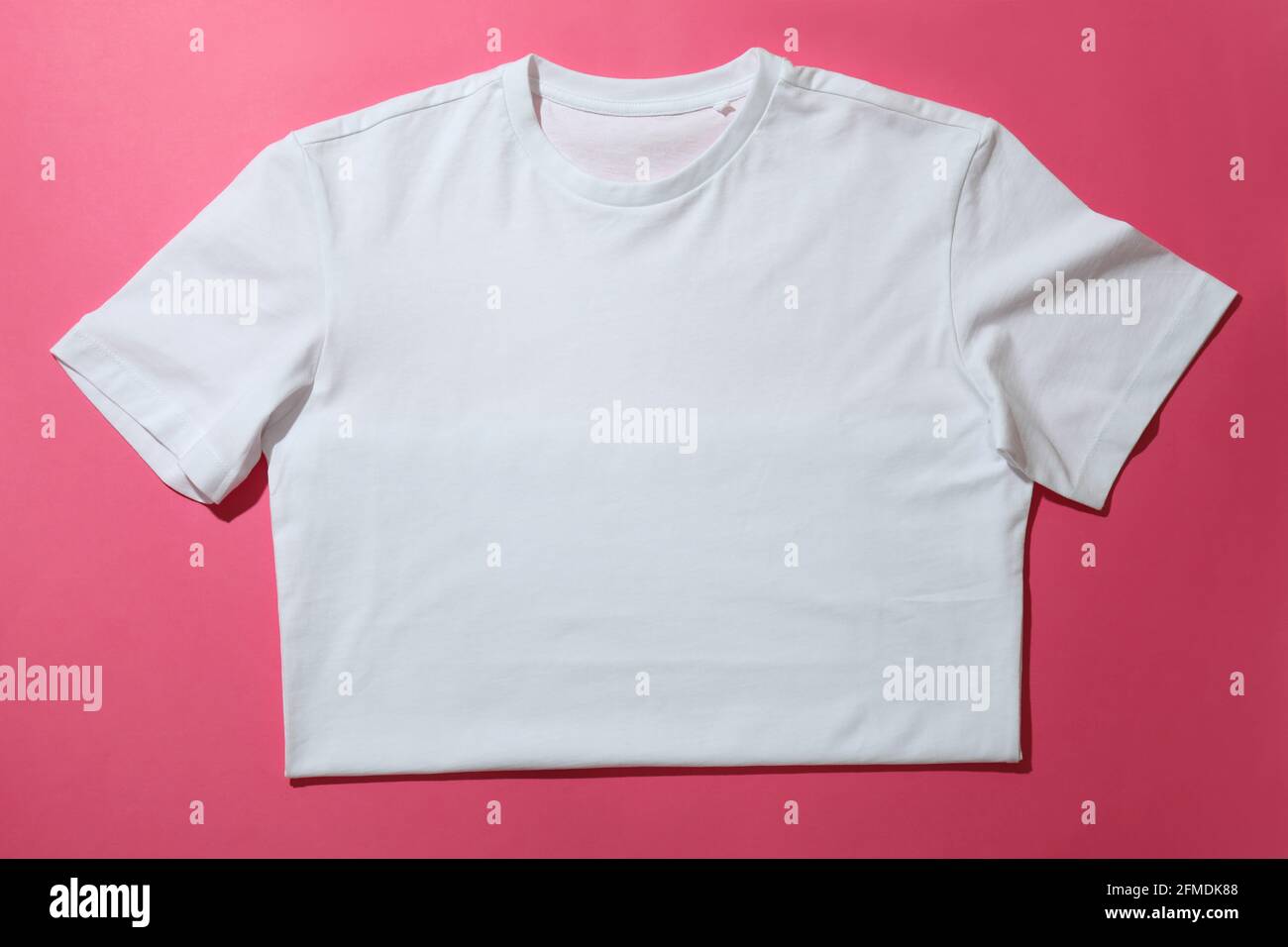 White t-shirt on pink background, space for text Stock Photo - Alamy