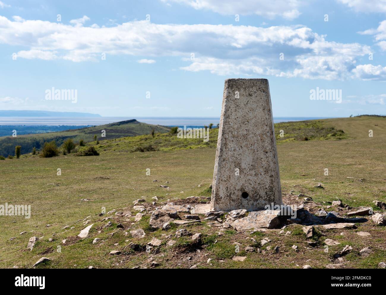 Trig point on Wavering Down in the Mendip HIlls of Somerset UK looking towards Crook peak and the Bristol Channel Stock Photo