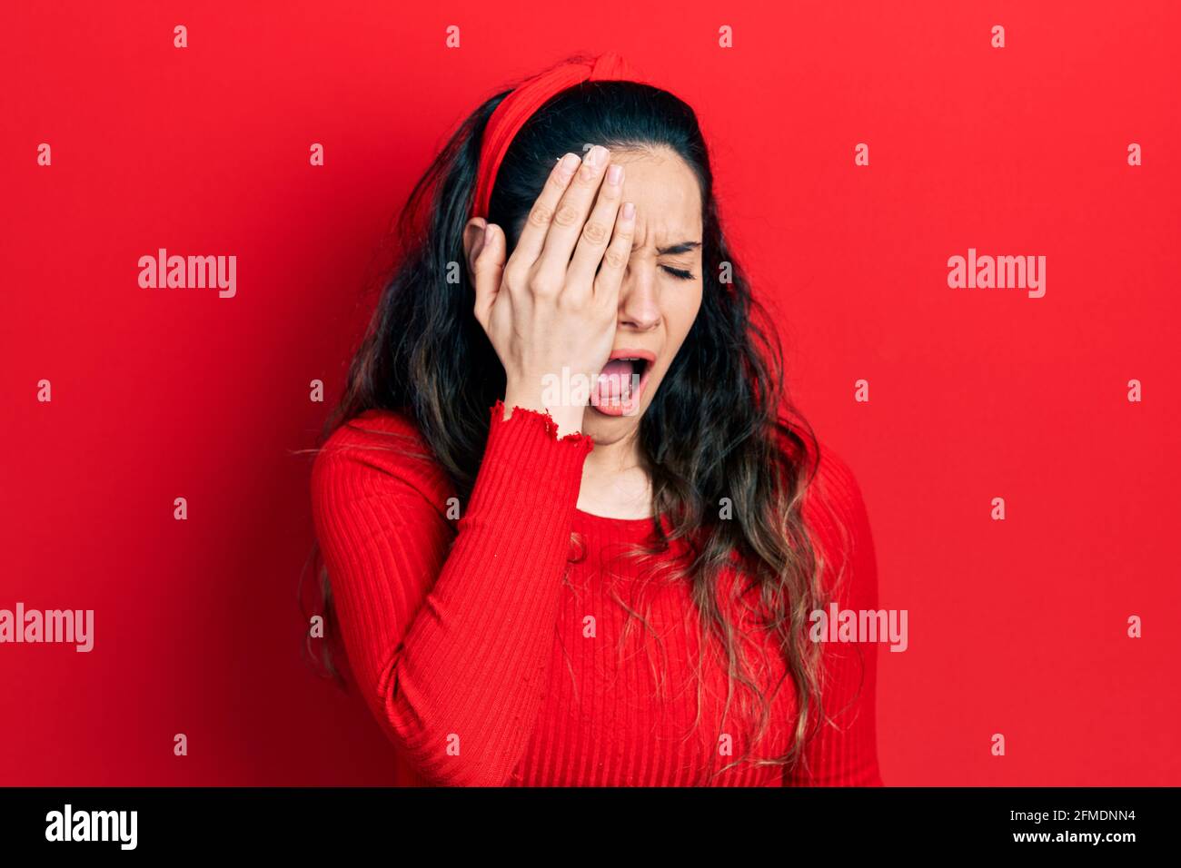 Young hispanic woman wearing casual clothes yawning tired covering half