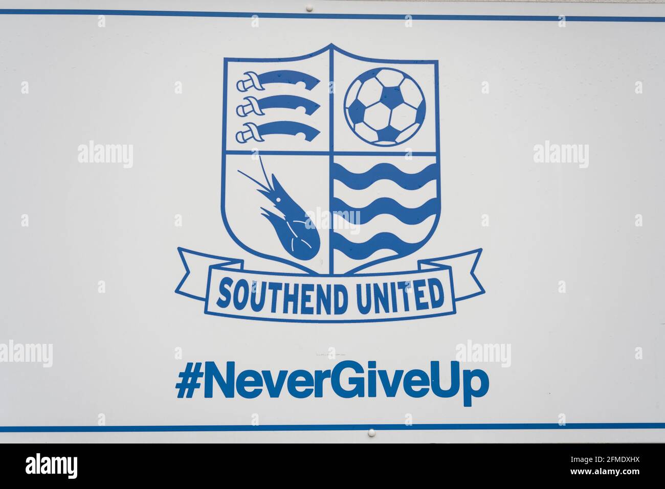 Never give up, club crest outside Roots Hall stadium home of Southend Utd as they played their final game of the season, their last before relegation Stock Photo