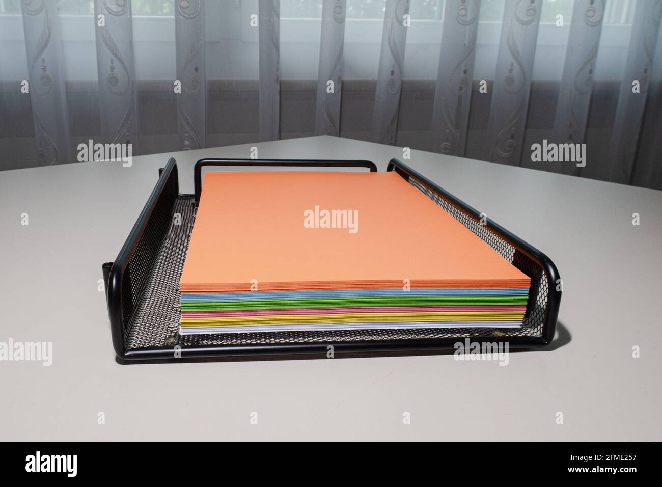 Zurich, Switzerland - June 13, 2020: The drawer with a pile of multicolored photocopy paper. Stock Photo