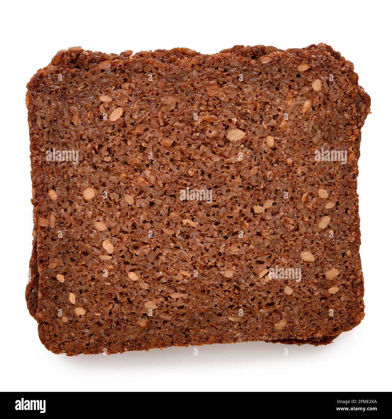 Two slices of German health bread with sunflower seeds isolated on white. Top view. Stock Photo