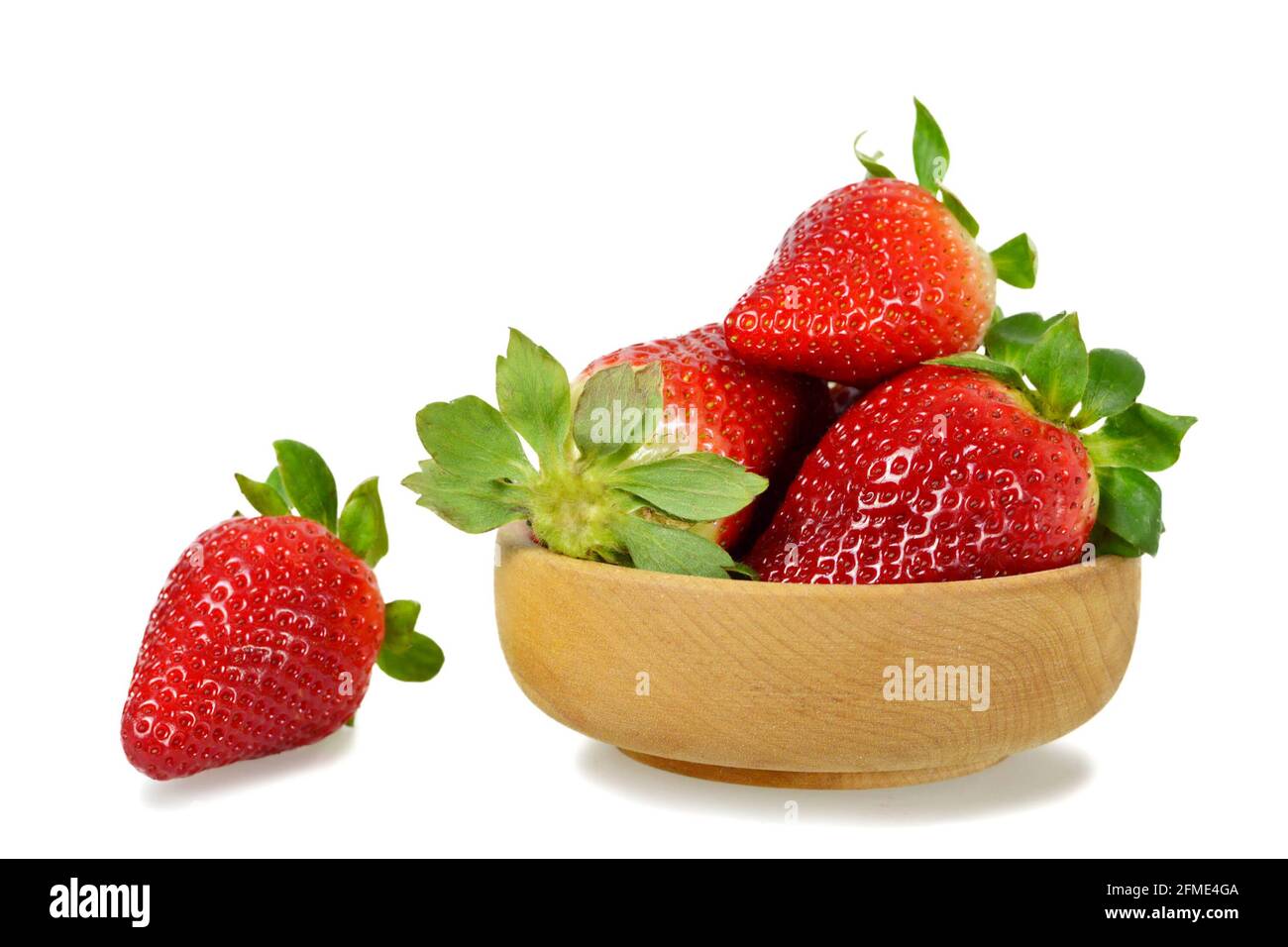 Strawberries in wooden bowl isolated on white background Stock Photo